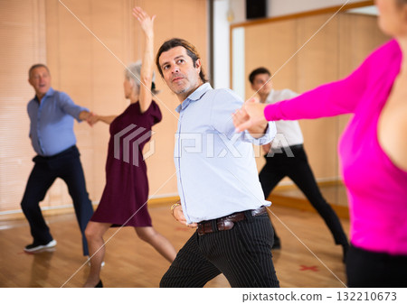 Man dancing jive with female partner in dance studio Man dancing jive with female partner in dance studio 132210673