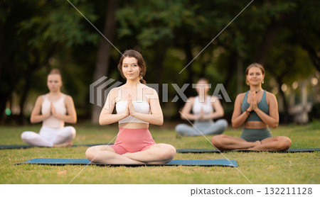 Group of young women doing yoga in lotus pose Group of young women doing yoga in lotus pose 132211128