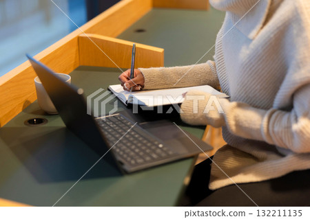 Student studying in library area 132211135