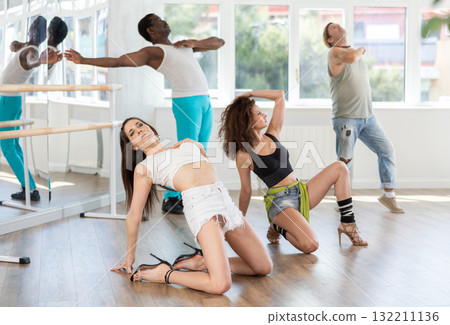 Women in heels dancing on floor in studio 132211136