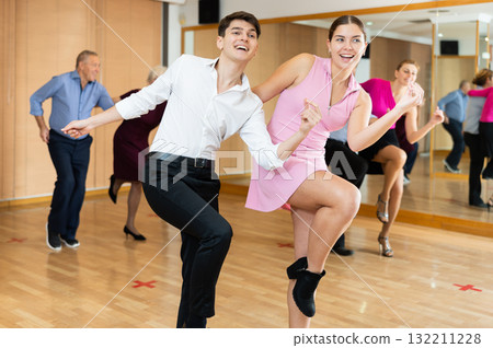 Young pair practicing Latino dance in dance studio 132211228