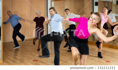 Middle-aged pair practicing Latino dance in dance studio 132211233