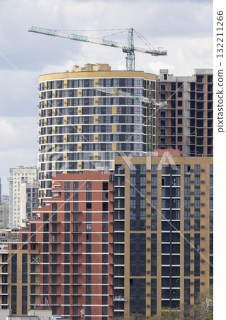Urban High-Rise Construction with Tower Crane and Modern Apartments 132211266
