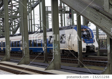 The train moves to the Cologne central station near the Hohenzollern bridge The train moves to the Cologne central station near the Hohenzollern bridge 132211288