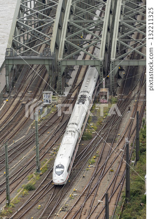 The train moves to the Cologne central station near the Hohenzollern bridge 132211325