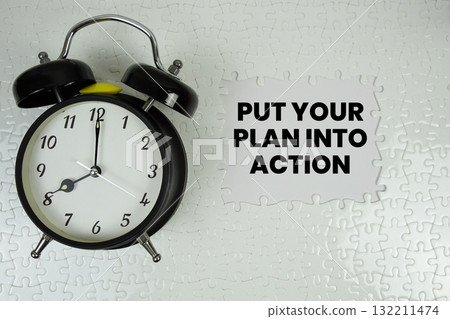 Jigsaw puzzle with a missing piece with "Put Your Plan Into Action" and alarm clock on white background Jigsaw puzzle with a missing piece with "Put Your Plan Into Action" and alarm clock on white background 132211474