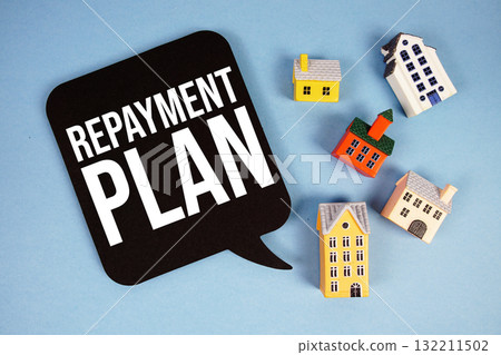 Repayment Plan text with house models on blue background Repayment Plan text with house models on blue background 132211502