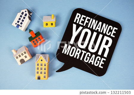 Refinance Your Mortgage text with house models on blue background Refinance Your Mortgage text with house models on blue background 132211503