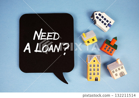 Need A Loan? text with house models on blue background Need A Loan? text with house models on blue background 132211514