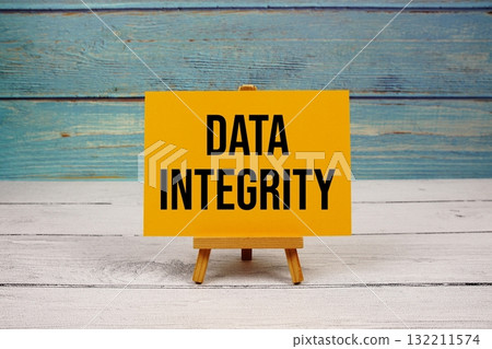 Data Integrity text written on paper card on wooden background Data Integrity text written on paper card on wooden background 132211574