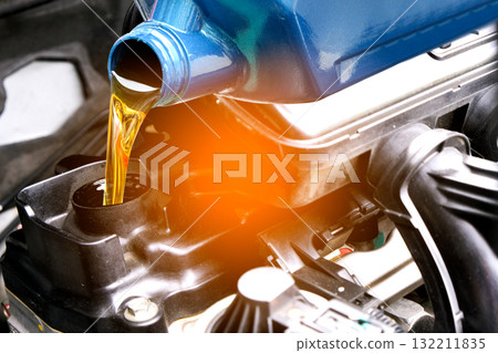 Refueling and pouring oil quality into the engine motor car Transmission and Maintenance Gear .Energy fuel concept. 132211835