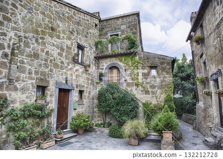 Ancient Stone Dwellings and Verdant Foliage in Civita di Bagnoregio Ancient Stone Dwellings and Verdant Foliage in Civita di Bagnoregio 132212728