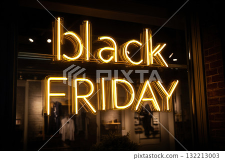 A fashion boutique is offering Black Friday discounts. The discounts are advertised in the form of a neon sign on the boutique's glass wall. 132213003