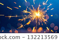 Sparkler Burning Bright Against Blue Bokeh Sparkler Burning Bright Against Blue Bokeh 132213569