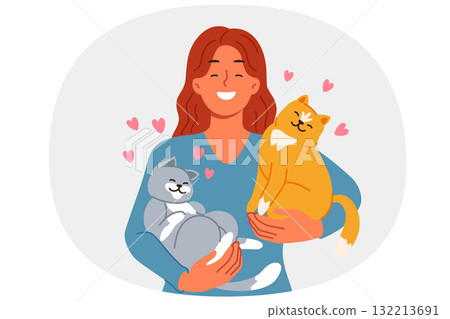 Woman with two cats in arms loves own pets found in shelter with homeless animals 132213691