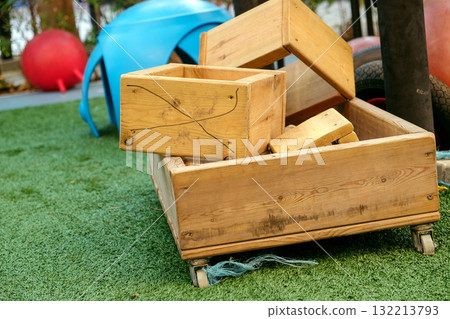 Wooden box for children's toys on green grass in the park 132213793