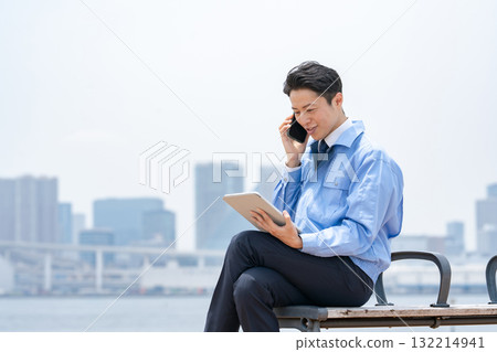 Man in work clothes making a phone call Tablet Man in work clothes making a phone call Tablet 132214941