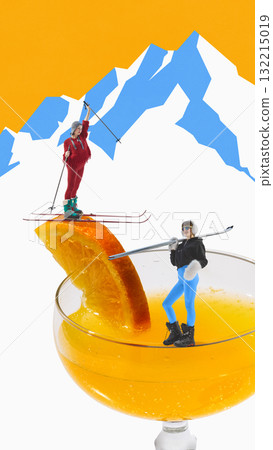 Two skiers in bright outfits standing on orange slice over cocktail glass with mountain view Two skiers in bright outfits standing on orange slice over cocktail glass with mountain view 132215019