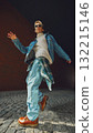 Young man in denim jacket walking confidently under city arch with modern attitude 132215146