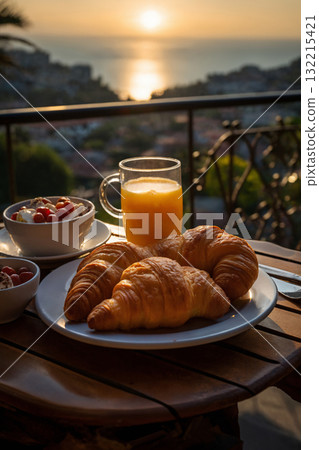 cup of coffee and french croissant on table, balcony with view of beautiful landscape, still life, sea and mountains, resort town, sunset 132215421