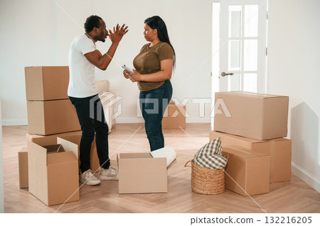 Arguing, having a quarrel. African American couple are moving into new house 132216205