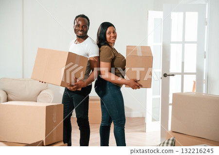 Bunch of boxes. African American couple are moving into new house Bunch of boxes. African American couple are moving into new house 132216245