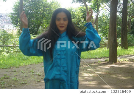 Woman taking a deep breath in nature 132216409