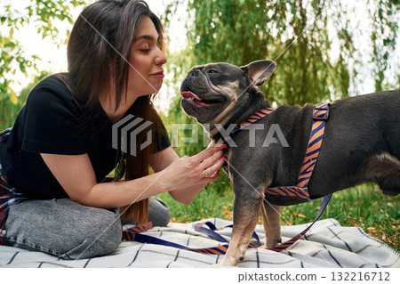 Young pretty woman is with her dog in the park 132216712