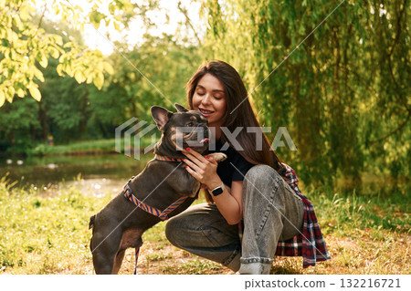 Lovely picture, sitting. Young pretty woman is with her dog in the park 132216721
