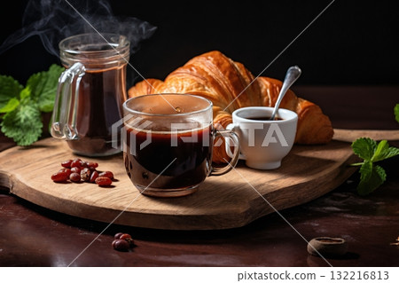 a cup of coffee and a fresh croissant, coffee beans and coarse cloth, still life on a dark background a cup of coffee and a fresh croissant, coffee beans and coarse cloth, still life on a dark background 132216813