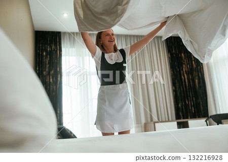 Busy, conception of work and occupation. Young chambermaid is in hotel room Busy, conception of work and occupation. Young chambermaid is in hotel room 132216928