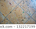 Paint-stained tiled floor in artist studio. Colorful marks and smudges from oil and acrylic paints left during creative work, showing real-life atmosphere of painting process. 132217199