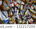 Close-up top view of numerous colorful paint tubes scattered across a messy work surface in an artist studio. Represents the creative process, artistic mess and inspiration behind painting. 132217200