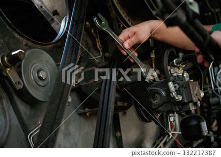 Mechanic working on industrial machinery in a workshop Mechanic working on industrial machinery in a workshop 132217387