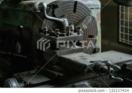 Vintage industrial lathe in an old workshop setting 132217424