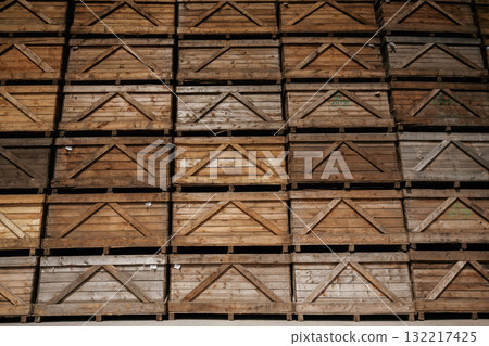 Stacked wooden crates in an organized warehouse setting 132217425