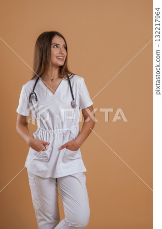 Joyful facial expression from a nurse. Young pretty woman is against background in the studio 132217964