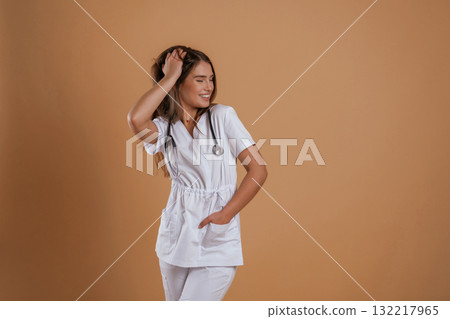 Young pretty nurse is against background in the studio 132217965