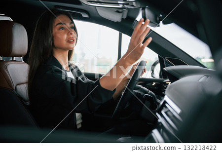 View from the side. Beautiful businesswoman is in the new car 132218422