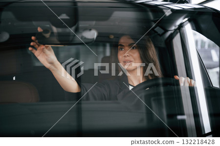 Testing before buying. Beautiful businesswoman is in the new car Testing before buying. Beautiful businesswoman is in the new car 132218428