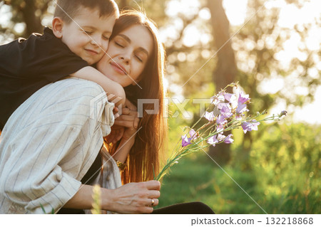Conception of care and love. Mother and son are in the forest together Conception of care and love. Mother and son are in the forest together 132218868
