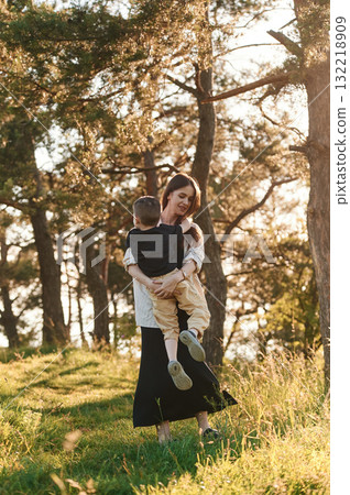 Fun times. Mother and son are in the forest together 132218909