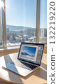 A laptop is open on a table. 132219220