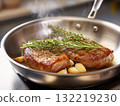 Succulent steak cooking in a skillet with fresh herbs 132219230