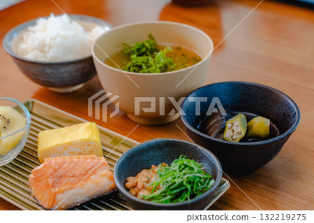 Japanese breakfast of grilled salmon, tamagoyaki (rolled egg), miso soup and natto Japanese breakfast of grilled salmon, tamagoyaki (rolled egg), miso soup and natto 132219275