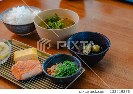 Japanese breakfast of grilled salmon, tamagoyaki (rolled egg), miso soup and natto Japanese breakfast of grilled salmon, tamagoyaki (rolled egg), miso soup and natto 132219276