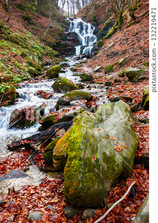 beautiful autumn scenery near the waterfall shypot. popular travel destination of Ukrainian Carpathians. mossy rocks near water stream. steep slopes in fallen foliage. sunny afternoon in autumn 132219471