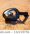 A snorkeling mask floats in the water on the sandy shore of the Red Sea, inviting adventurers to explore the underwater wonders 132219756