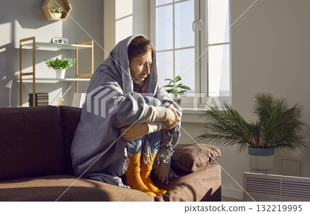Young man gets frozen inside his house or apartment because of a very cold winter 132219995