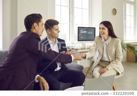 Businessmen and businesswoman meet in the office, make a successful deal and exchange handshakes Businessmen and businesswoman meet in the office, make a successful deal and exchange handshakes 132220109